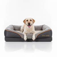 Dog lying on a gray and orange pet bed with 'Dog Lush' branding on a white background