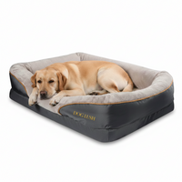 Dog lying on a gray and black pet bed with 'Dog Lush' branding.