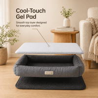 Gray pet bed with Cooling Gel Mat on a wooden floor in a living room setting.